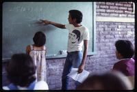 A Cuban math teacher explains an exercise to his students at a public school, Nicaragua