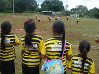 Girls stand on the sideline during a soccer match at la Olympiada in Cuipo, Panama